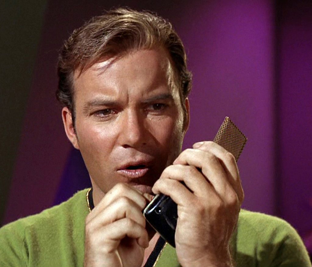 James Kirk with a hand-held communicator